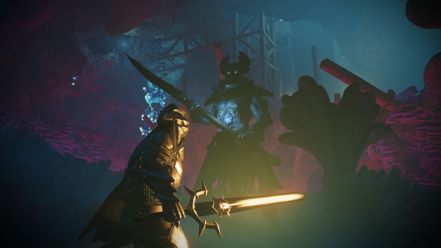 An Enshrouded player with a glowing golden sword faces off against a large horned enemy in a dark cave
